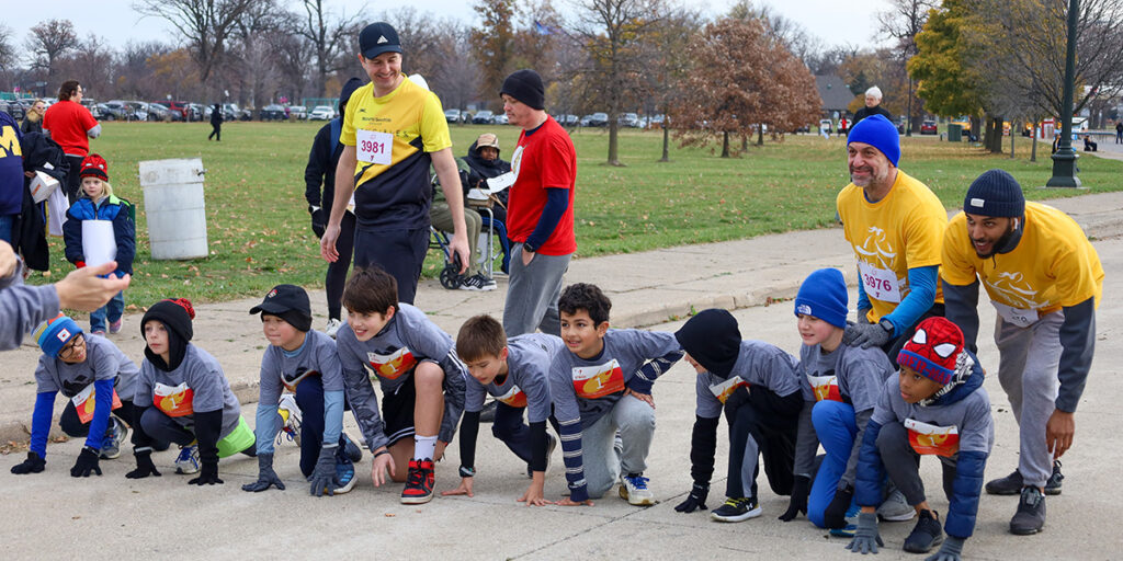 a group of PACE running program participants stretching before the 5K