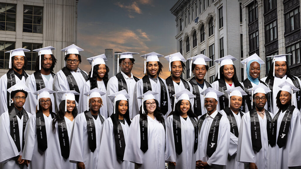 a group of high school students who participated in the Achievers program in graduation robes