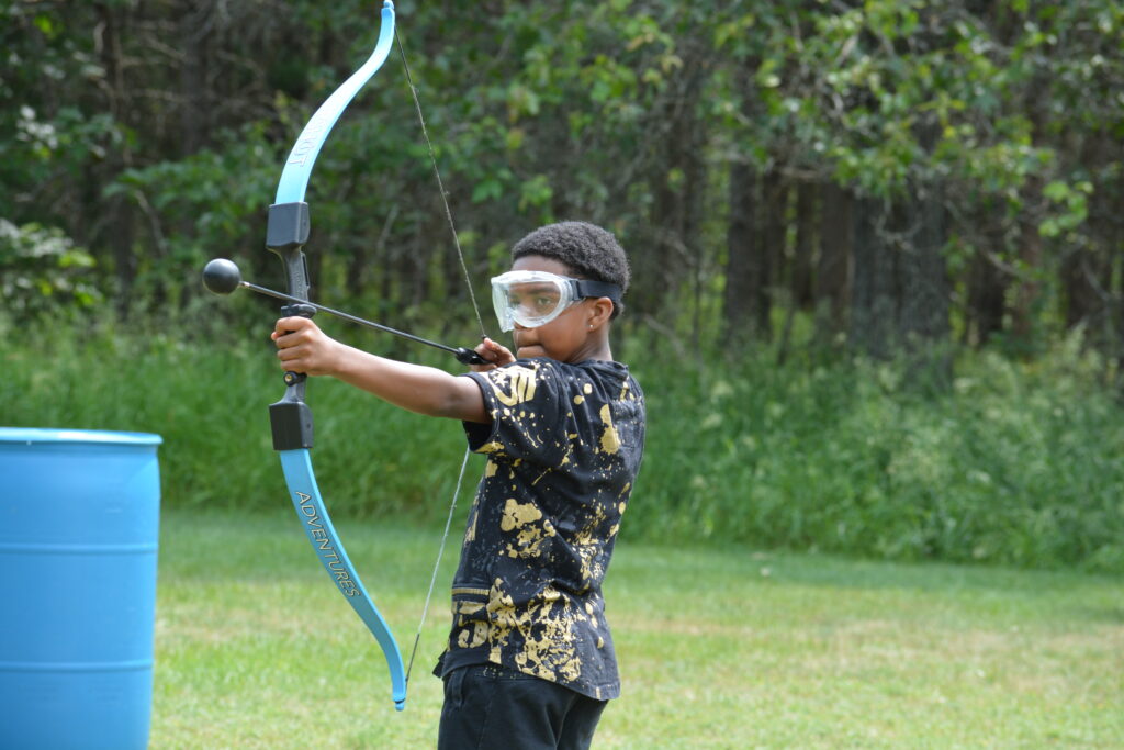 arrow tag - a kid practicing how to use bow and arrow