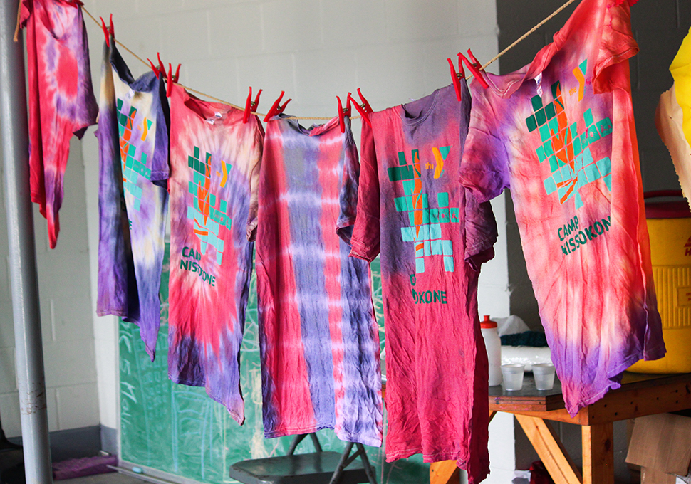 a photo of tie-dyed t shirts hanged while drying