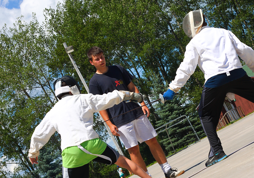 a photo of guys practicing fencing