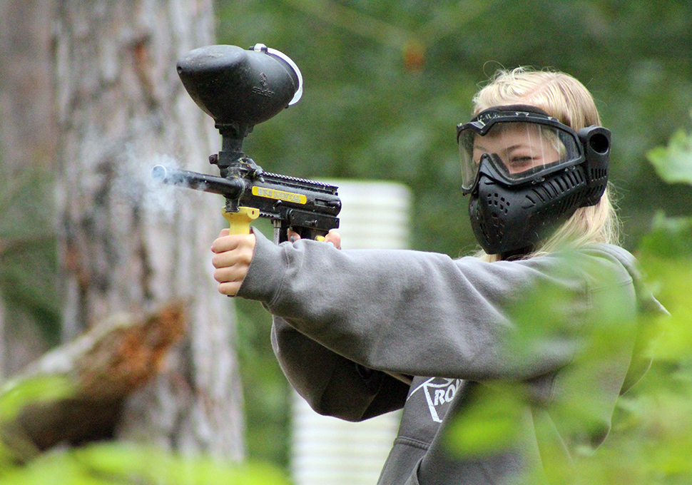 a photo of a woman wearing a mask with a smoke gun-like apparatus