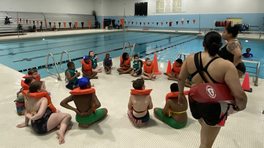 YMCA Safety Around Water program - a picture of women wearing floaters beside a swimming pool

