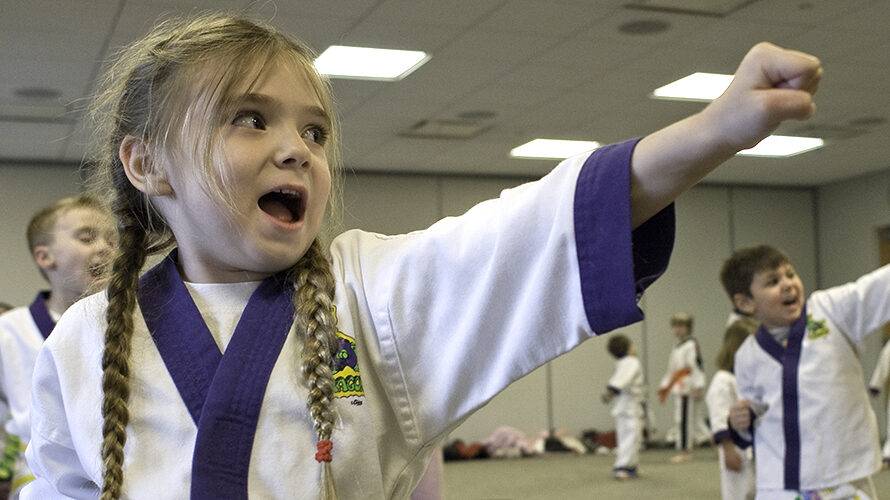 youth martial arts - a photo of a young girl doing martial arts in uniform