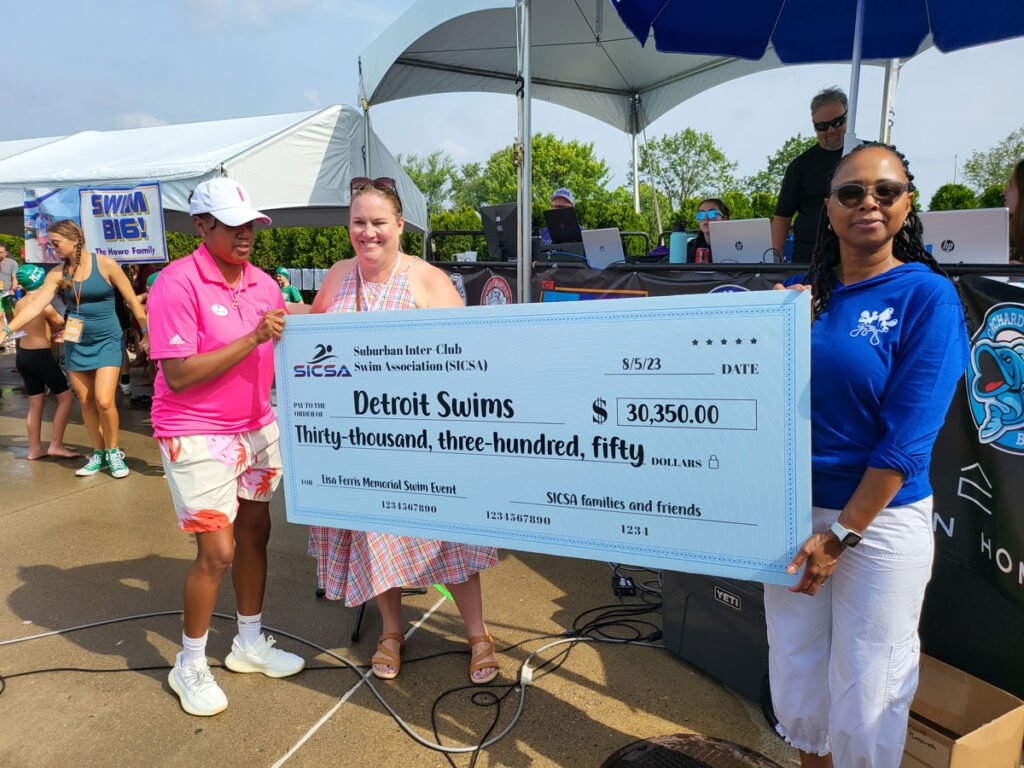 Donation check presentation for Detroit Swims from SISCA