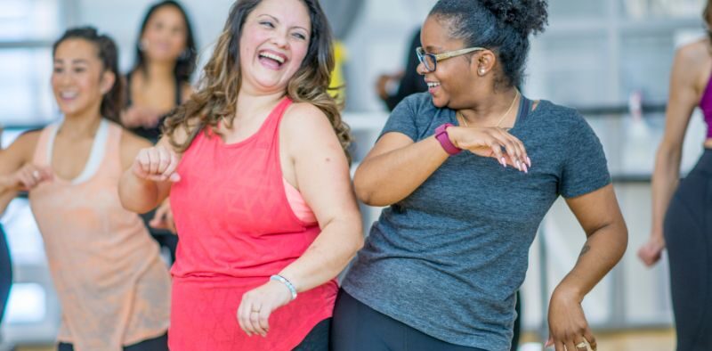 two members working out together in a YMCA group exercise class