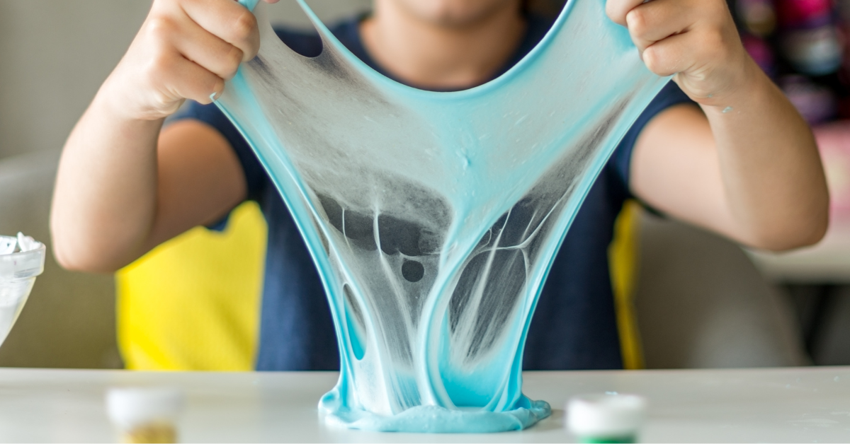 A kid playing with blue slime