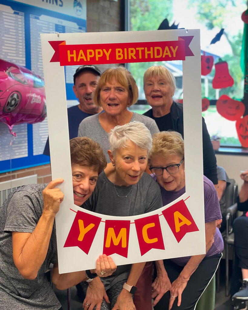 a group of older adults at the Birmingham Family YMCA celebrating the YMCA's birthday